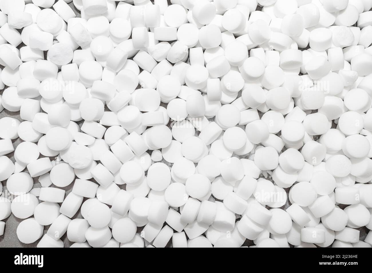 Background made of salt tablets for a water softener, large round cubes Stock Photo Alamy