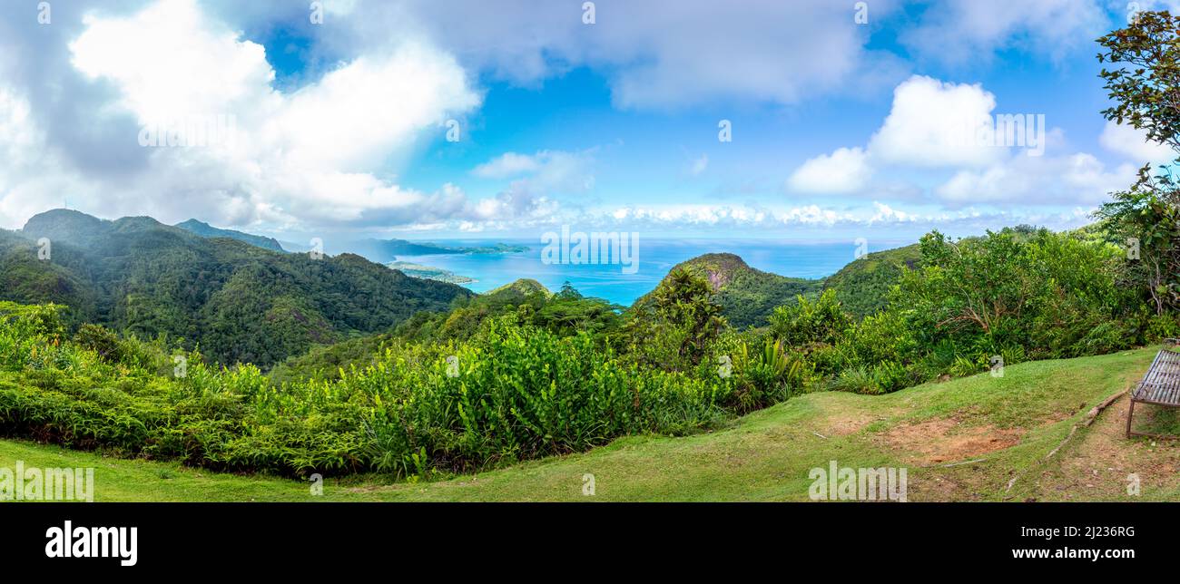 Mahe Island coast panorama seen from Venn's Town - Mission Lodge wooden viewing platform, lush tropical forest with crystal blue Indian Ocean. Stock Photo