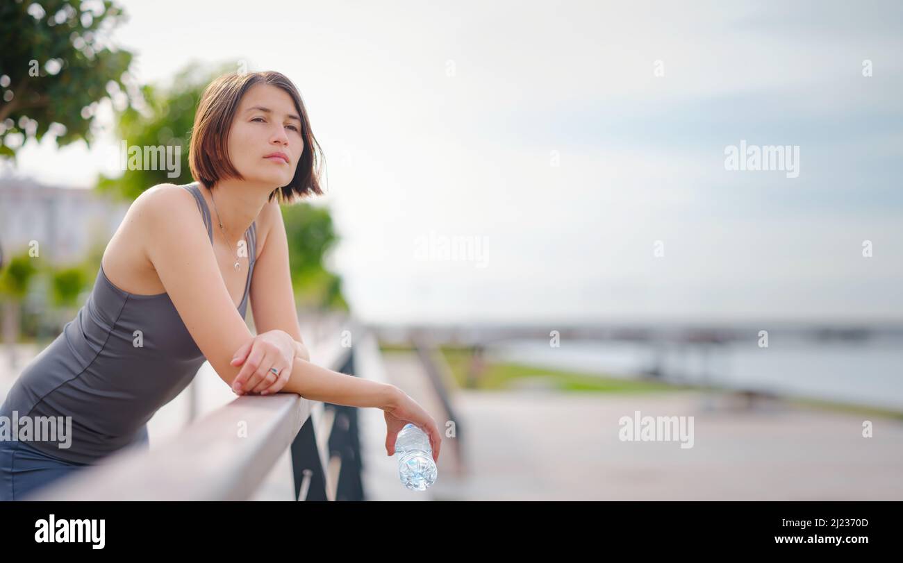 asian young strong, confident woman in sportive clothes feeling bad