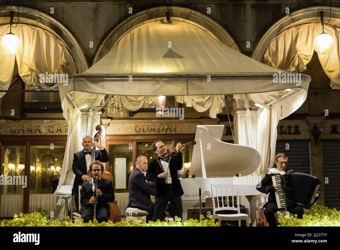 Italy, Venice, Piazza San Marko, classical musicians playing music at an outdoor cafe Stock Photo