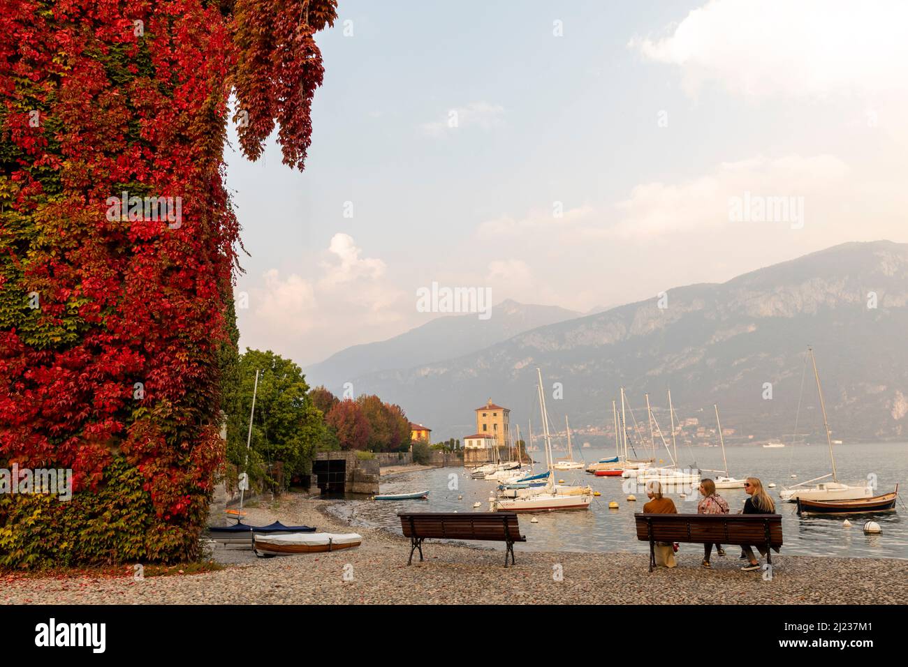 Italy, Lake Como, Varenna, three ladies on a park bench enjoying the view of Lake Como Stock Photo