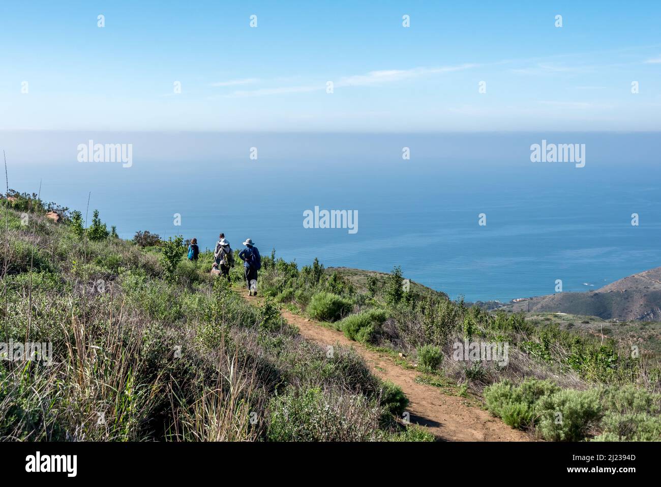 A family hikes above the Pacific Ocean at Charmlee Wilderness Park near Malibu, an area burnt by the Woolsey wildfire now reopened for recreation Stock Photo