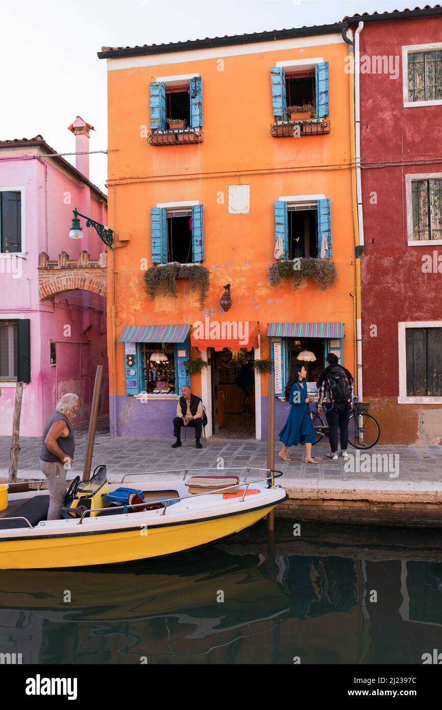 Italy, Venice, Colourful houses and shops on a canal on the Venetian island of Burano Stock Photo