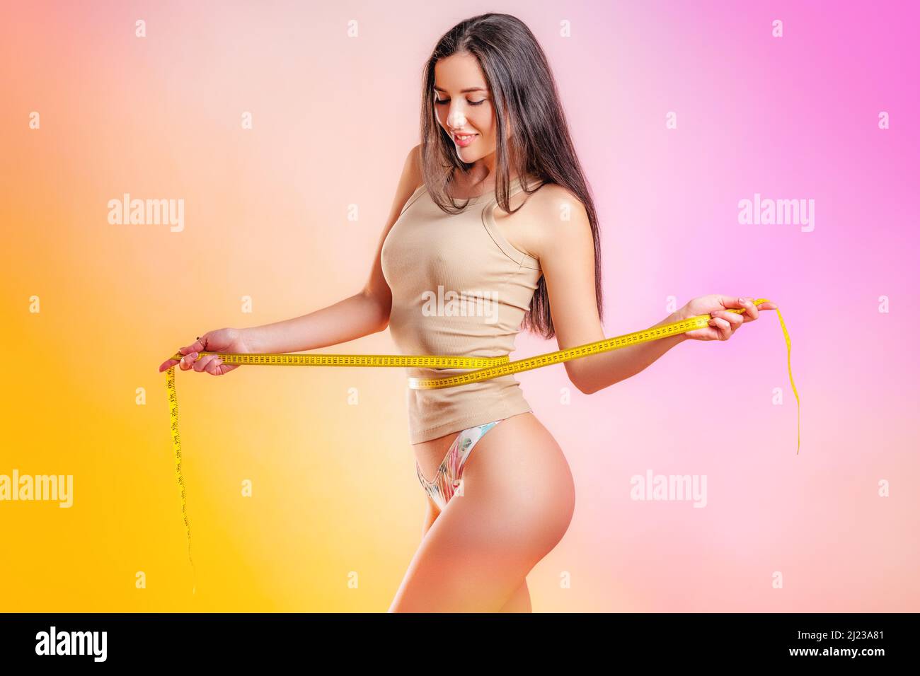 young beauty with a measurement tape Stock Photo