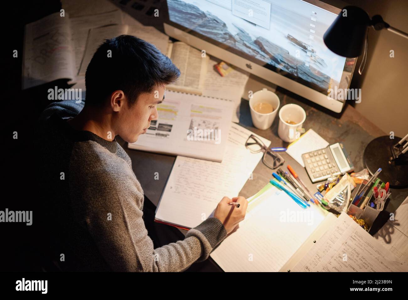 All night cramming. Cropped shot of a young student studying late into the night. Stock Photo