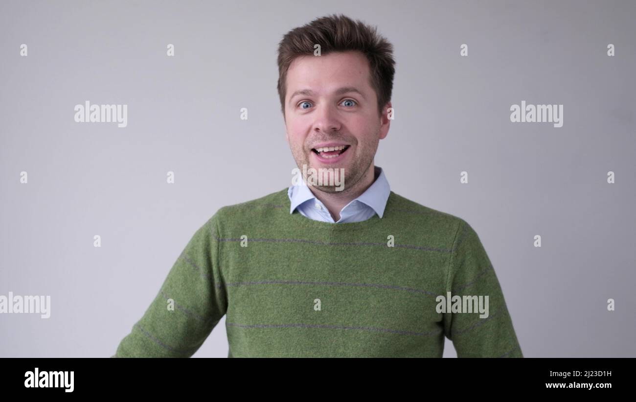 Cheerful young man smiling at camera. Studio shot Stock Photo