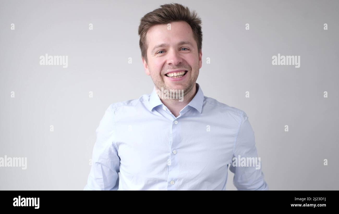Cheerful young man smiling at camera. Studio shot Stock Photo