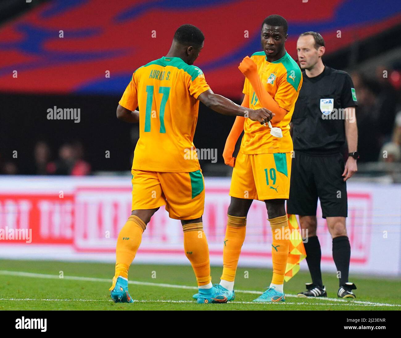 Ivory Coast's Serge Aurier (left) leaves the game after being shown a red card, walks past team-mate Nicolas Pepe during the international friendly match at Wembley Stadium, London. Picture date: March