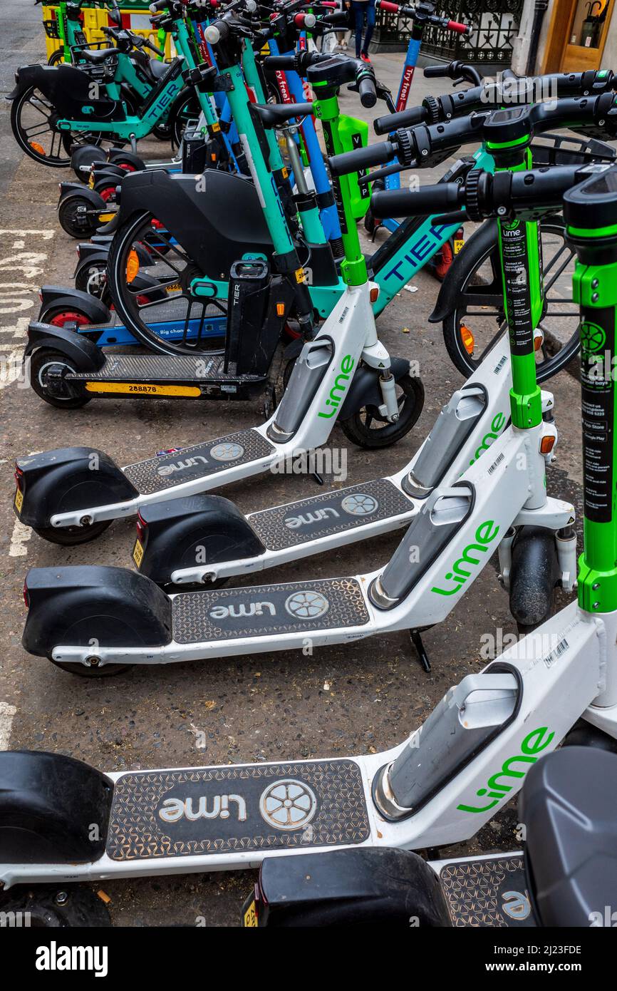 E-Scooters London - E-Scooters parked in designated space in Central London. Approved E-Scooters for hire in London. Stock Photo