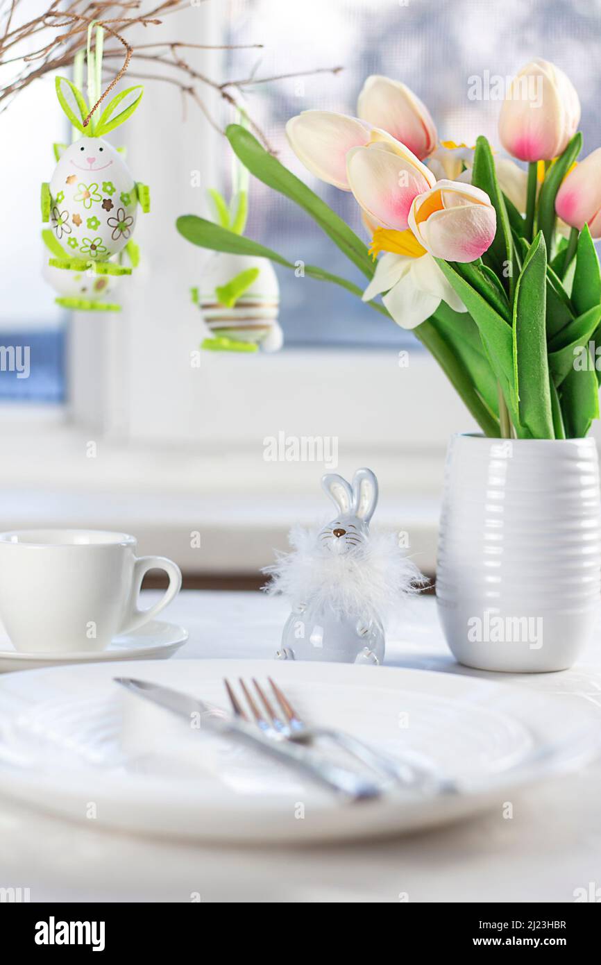 Easter table setting. Easter dinner with colorful Easter eggs. Easter background. Christ is risen Stock Photo