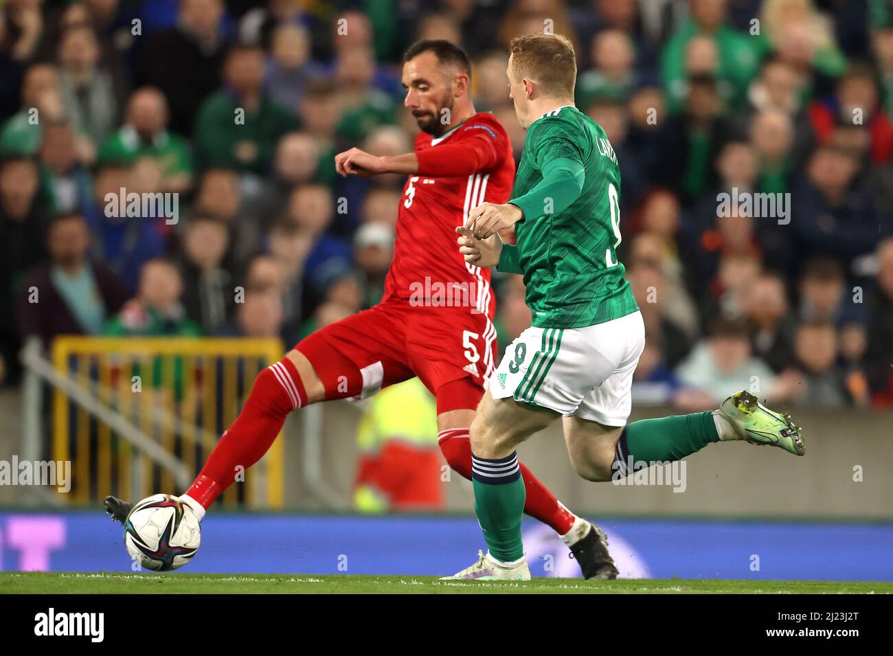 Northern Ireland's Shayne Lavery (right) and Hungary's Attila Fiola battle for the ball during the international friendly match at Windsor Park, Belfast. Picture date: Tuesday March 29, 2022. Stock Photo