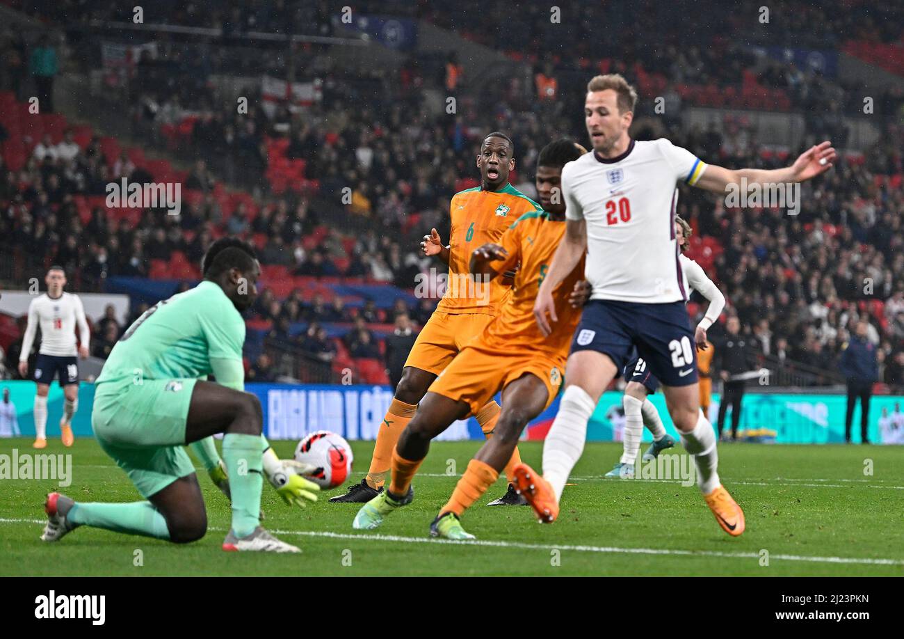 London, UK. 29th Mar, 2022. Badra Ali Sangare (Ivory Coast, goalkeeper) collects as Harry Kane (England, captain) tries to get to the ball during the International Friendly match between England and Ivory Coast at Wembley Stadium on March 29th 2022 in London, England. (Photo by Garry Bowden/phcimages.com) Credit: PHC Images/Alamy Live News Stock Photo