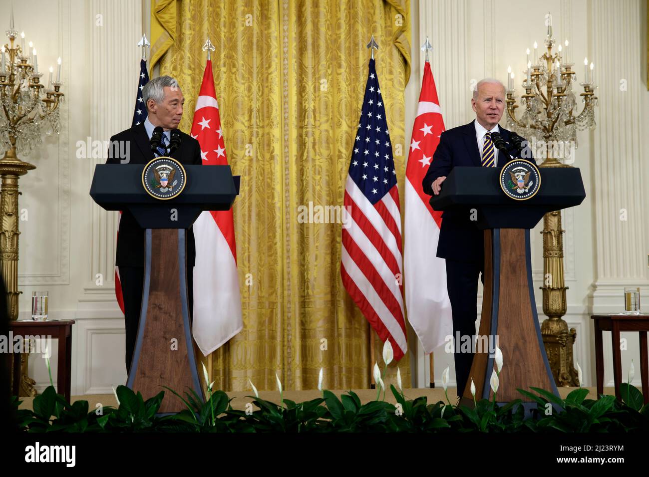Washington, DC, USA. 29th Mar, 2022. U.S. President Joe Biden speaks during a joint statement with Lee Hsien Loong, Singapore's prime minister, left, in the East Room of the White House in Washington, DC, U.S., on Tuesday, March 29, 2022. Biden thanked Lee Hsien Loong for supporting Ukraine during a meeting this morning and said the two leaders would discuss U.S. strategy in the Indo-Pacific region. Credit: Samuel Corum/Pool via CNP/dpa/Alamy Live News Stock Photo