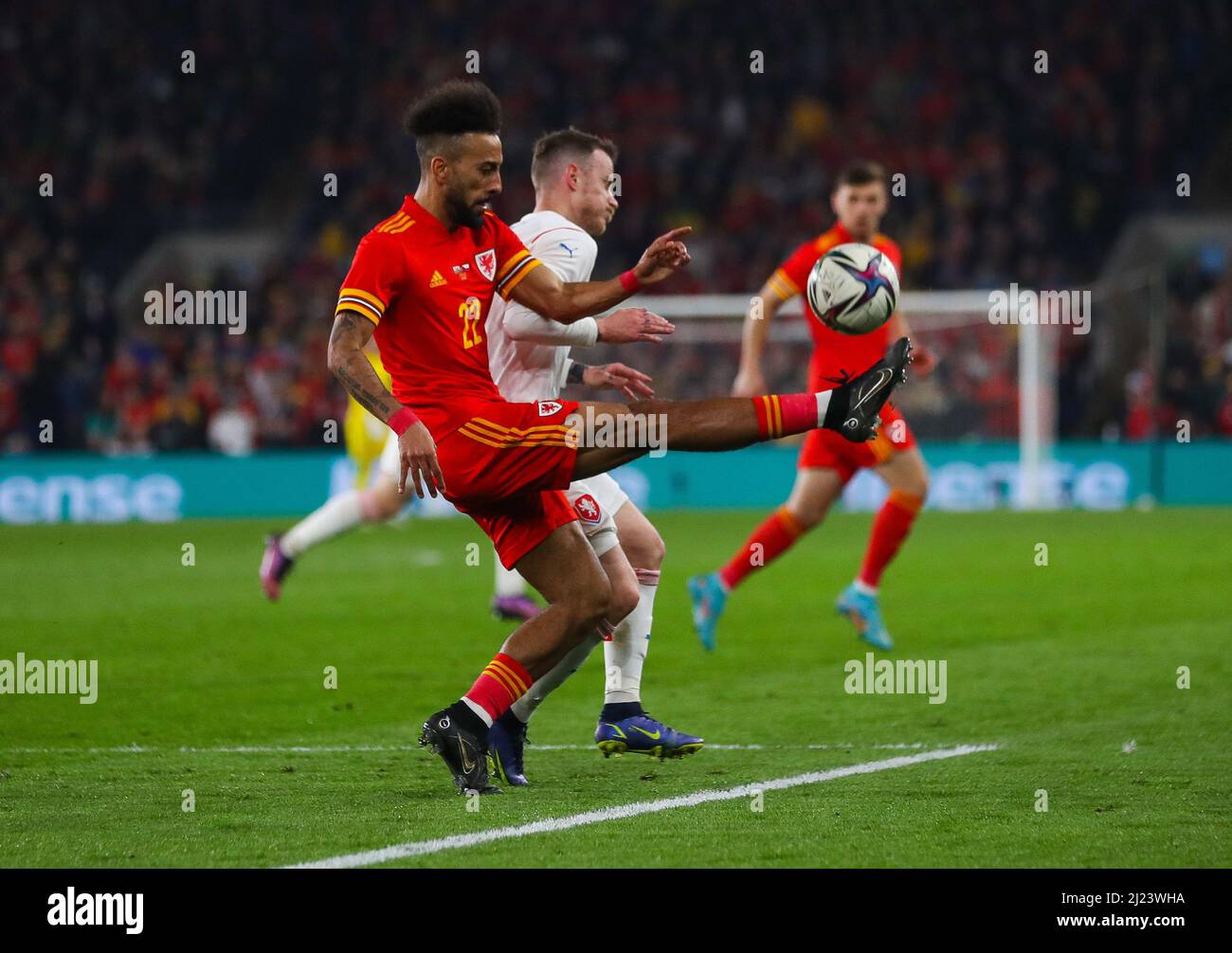 29th March 2022 ;  Cardiff City Stadium, Cardiff, Wales; International football friendly, Wales versus Czech Republic; Sorba Thomas of Wales clears the ball while under pressure from Jan Sykora of Czech Republic Stock Photo