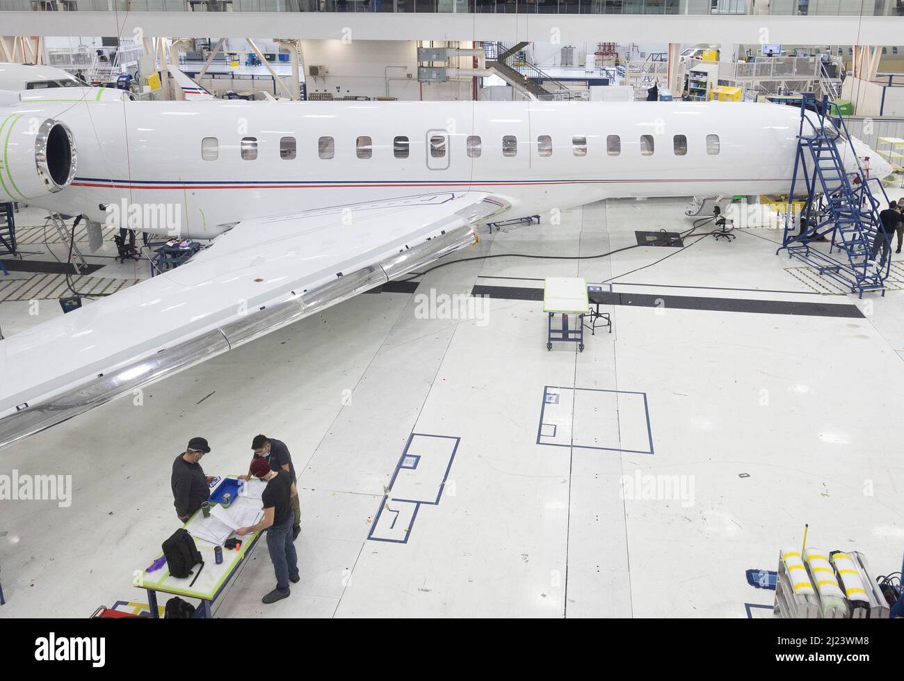 Bombardier employees work on interior completions and exterior touch