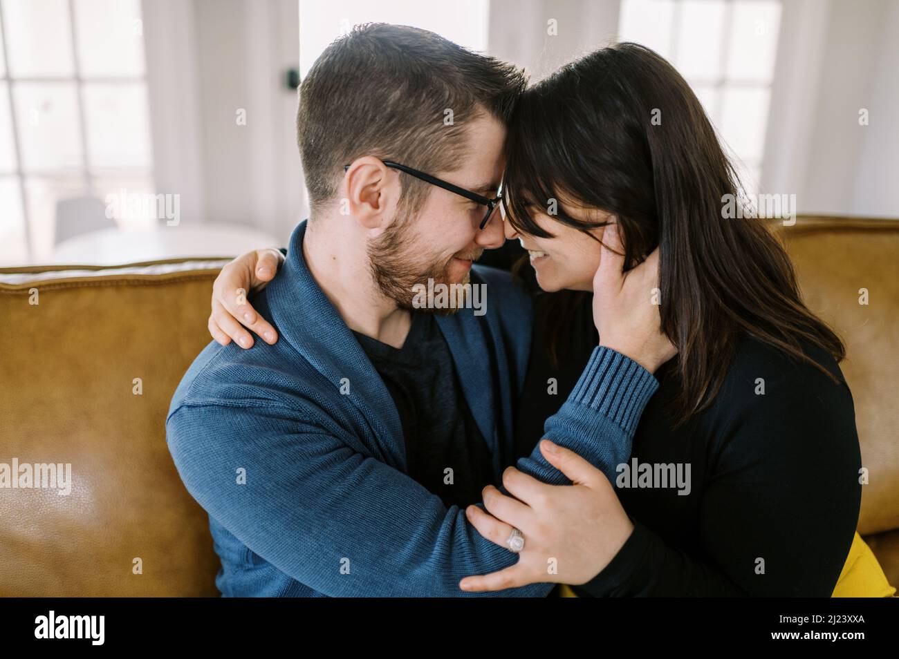 Couple hugging on couch hires stock photography and images Alamy