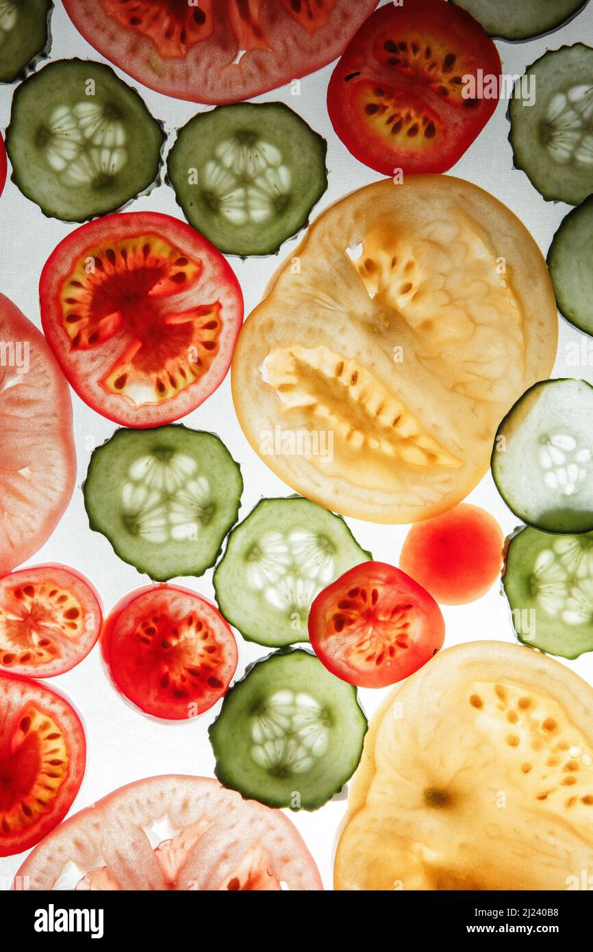 cucumbers and tomatoes sliced ??on a white background Stock Photo