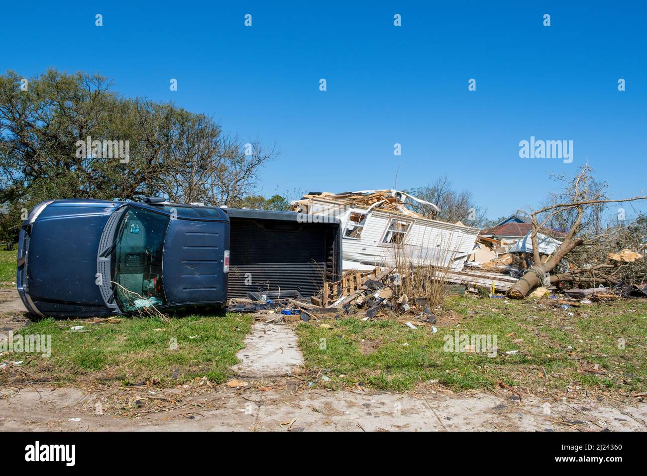 ARABI, LA, USA - MARCH 26, 2022: Pickup truck flipped on its side and house destroyed by March 22, 2022 tornado Stock Photo