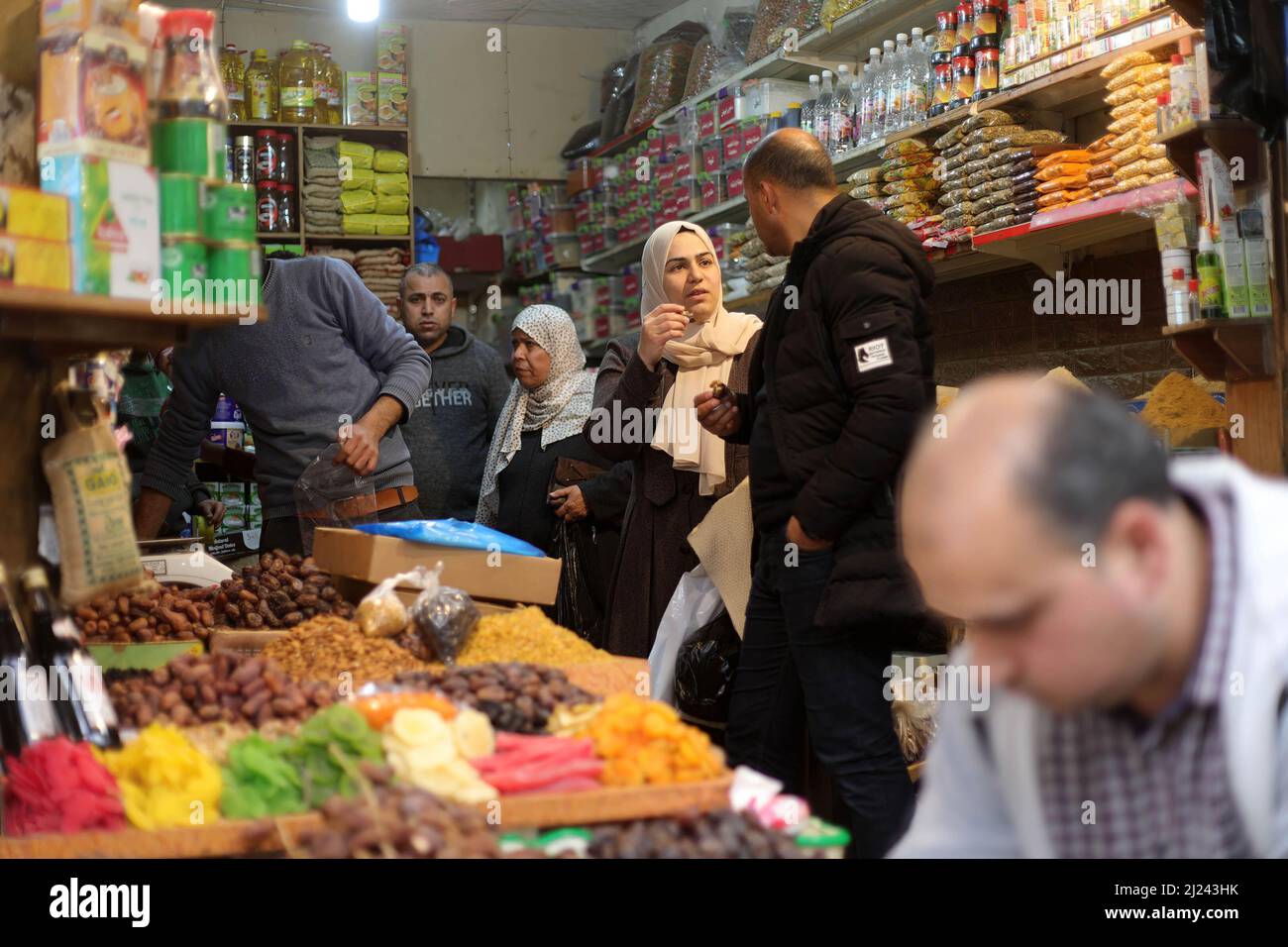 Palestinians shop from the old popular 'Al-Zawya' market ahead of Ramadan in Gaza City. Palestinians prepare themselves ahead of the holy month of Ramadan by shopping in the oldest popular market called Al-Zawya middle of Gaza City, despite the high price of the goods in general caused by the Russian invasion of Ukraine. Muslims fast in Ramadan month, which is considered one of the pillars of Islam, in which Muslims abstain from eating and drinking until sunset. Stock Photo