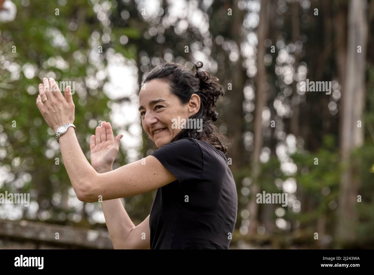 white caucasian woman dancing alone in the forest in spring time Stock Photo