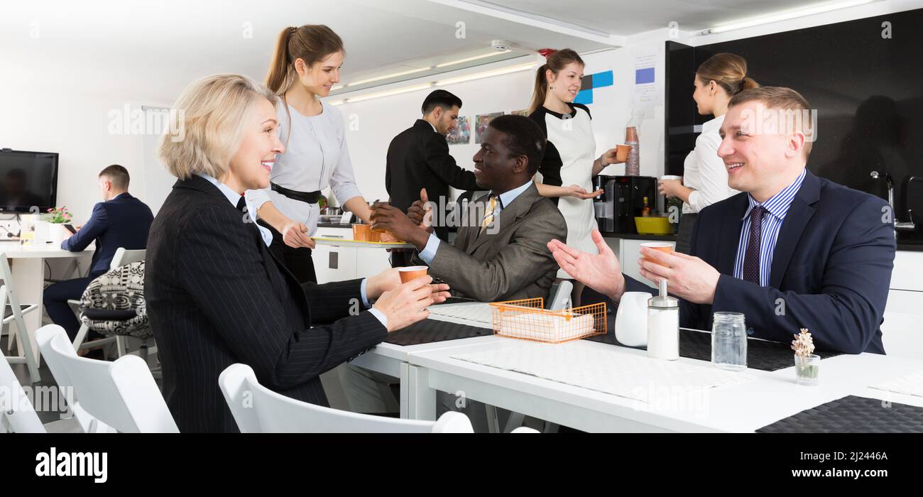 business people chatting while enjoying coffee Stock Photo