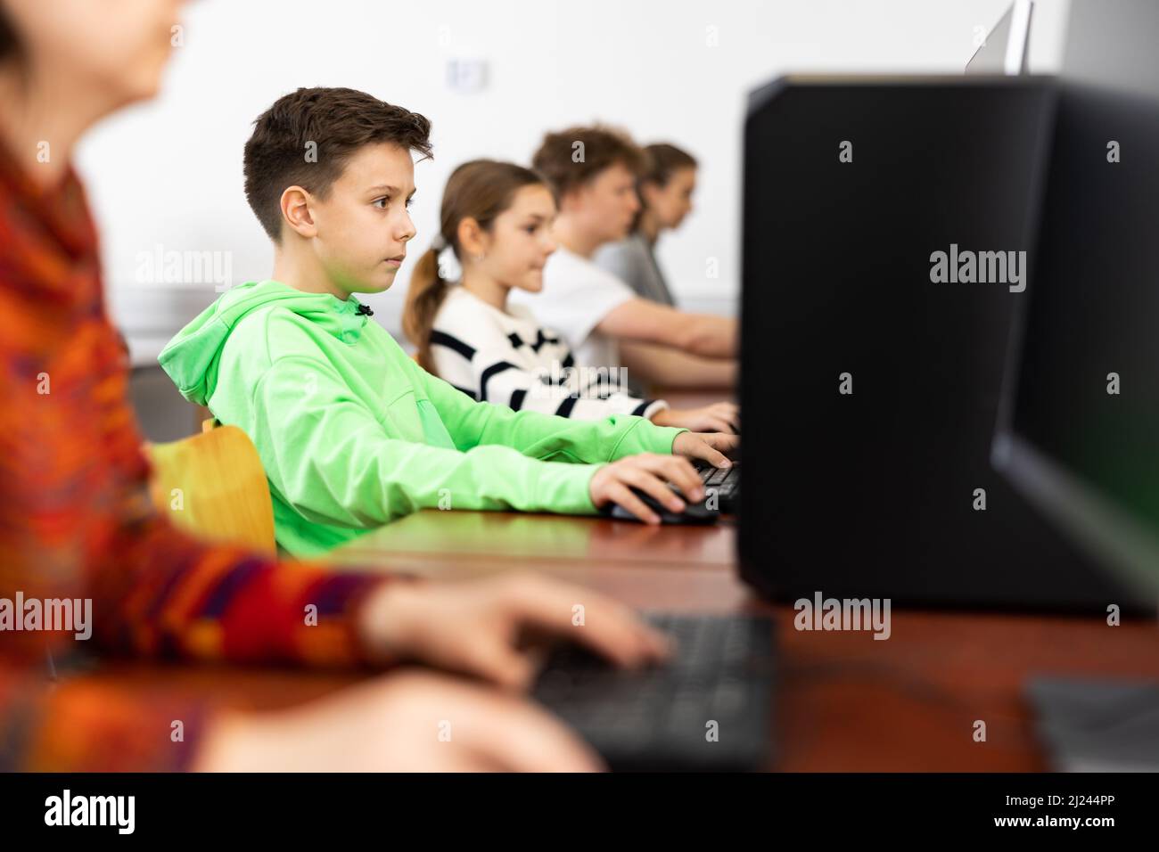 Interested preteen schoolboy during lesson in computer class Stock ...