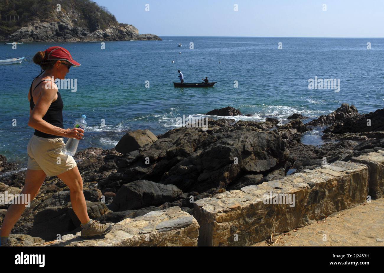Single woman walking around the bay in Port Chiapas, Mexico Stock Photo