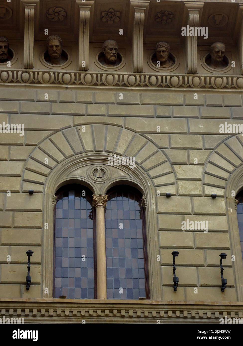 Medieval Gothic bifora window with ornate stone carvings in Italy Stock ...