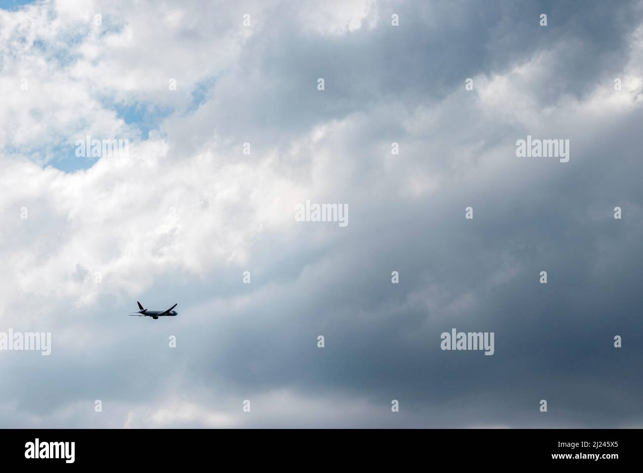 plane flying on a cloudy sky Stock Photo - Alamy