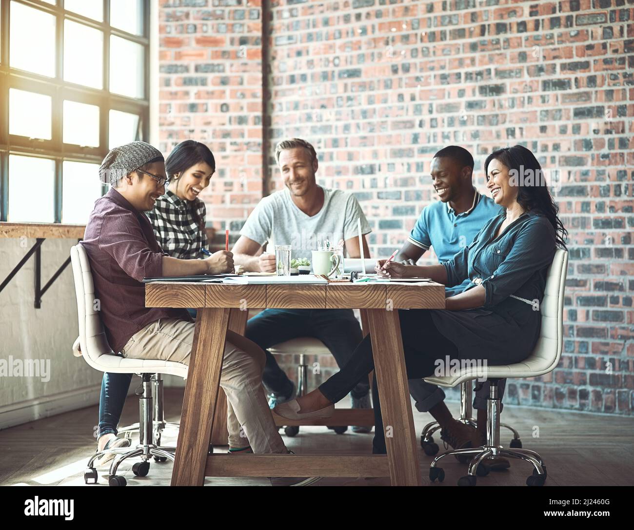 Team. Together everyone achieves more. Shot of a team of entrepreneurs collaborating in a modern office. Stock Photo