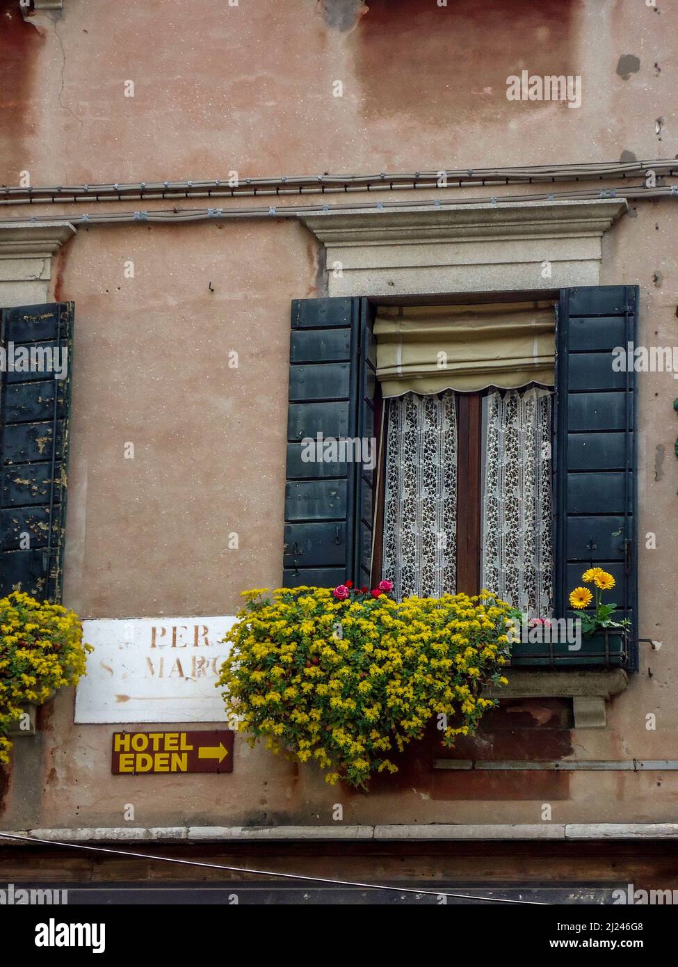 Rustic Italian Window With Shuttered Blinds And Yellow Flowers Stock ...