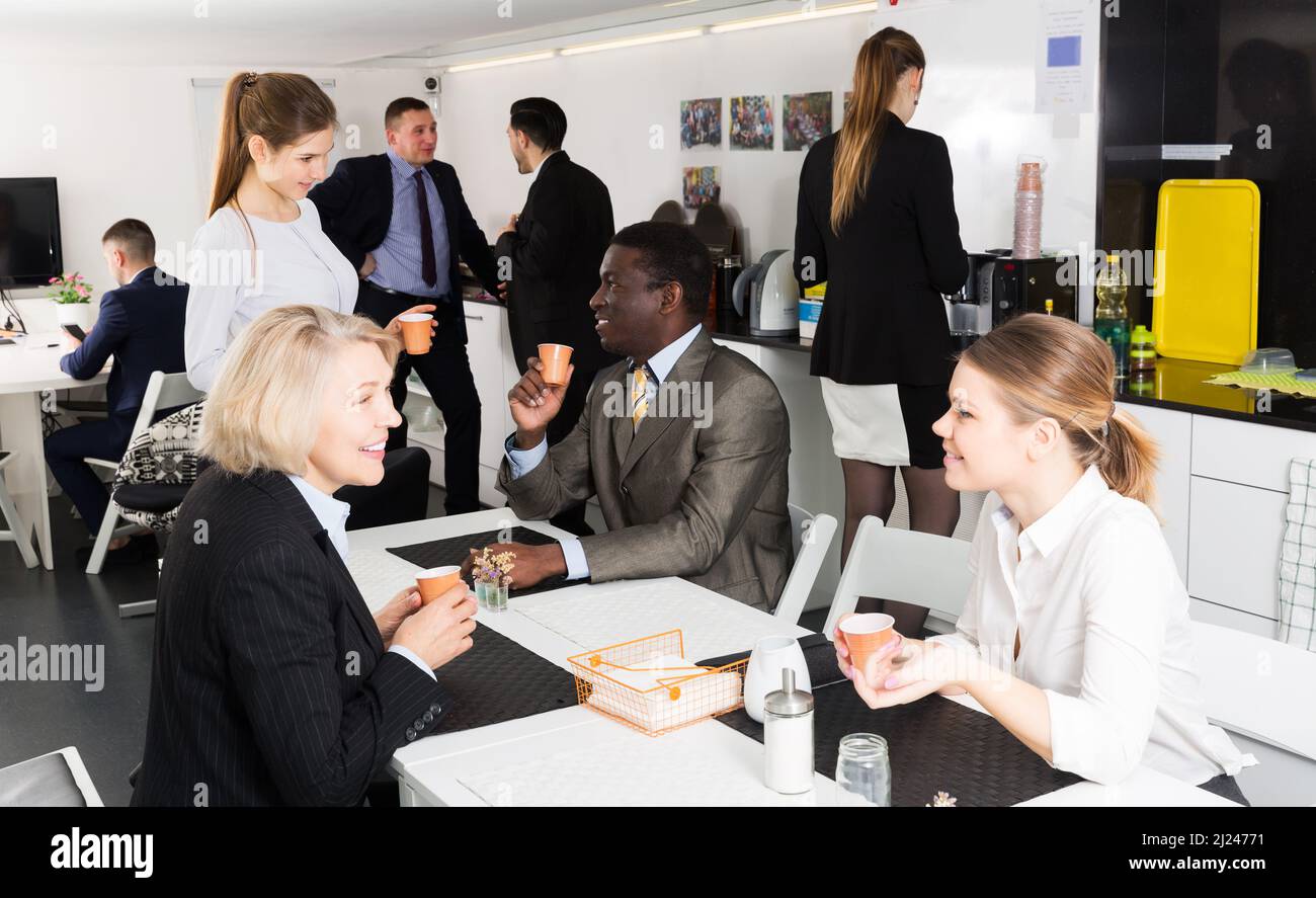 business people chatting while enjoying coffee Stock Photo