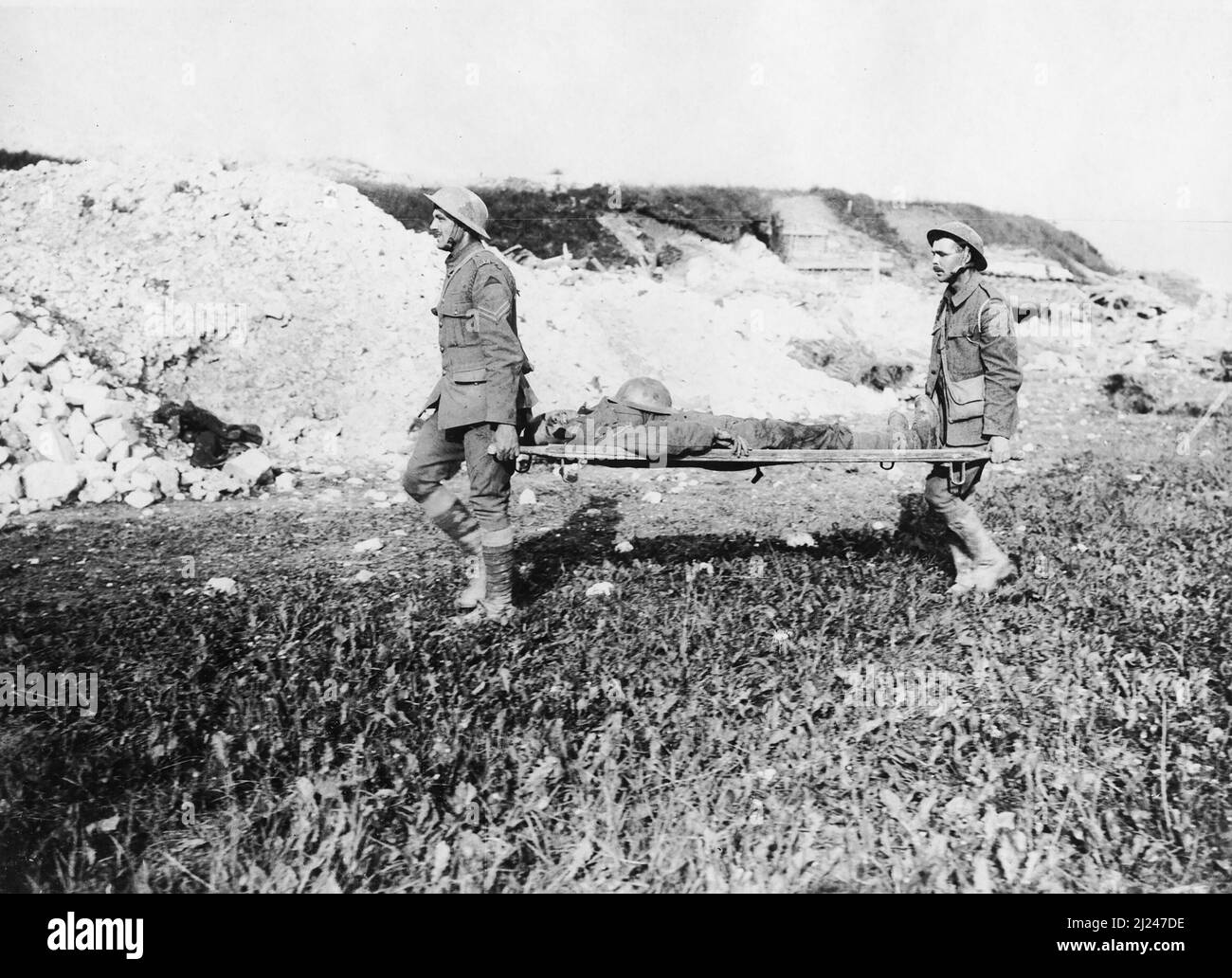 Two soldiers carrying a wounded soldier on a stretcher, France. Stock Photo