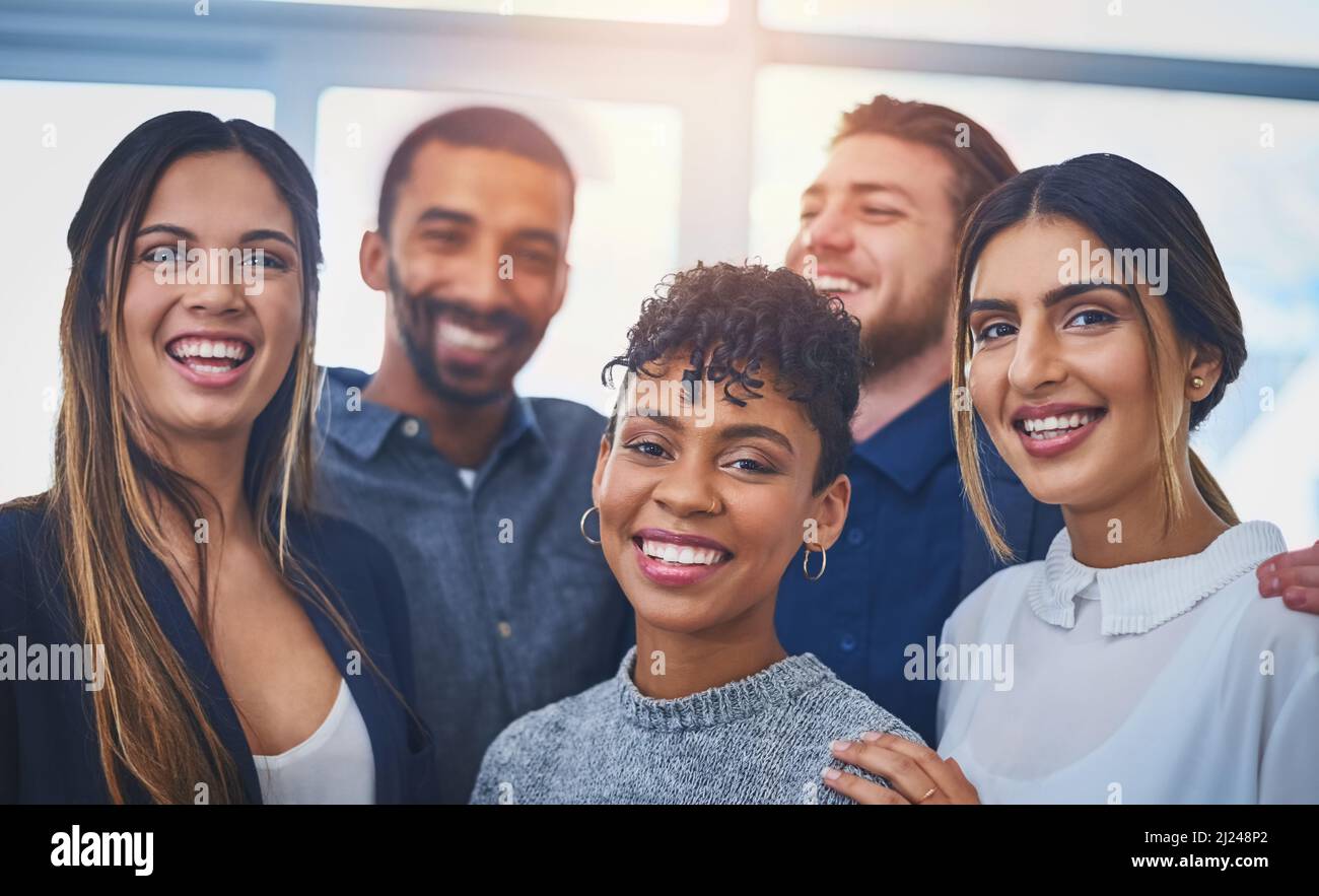 Were making waves in the business world. Portrait of a cheerful group ...