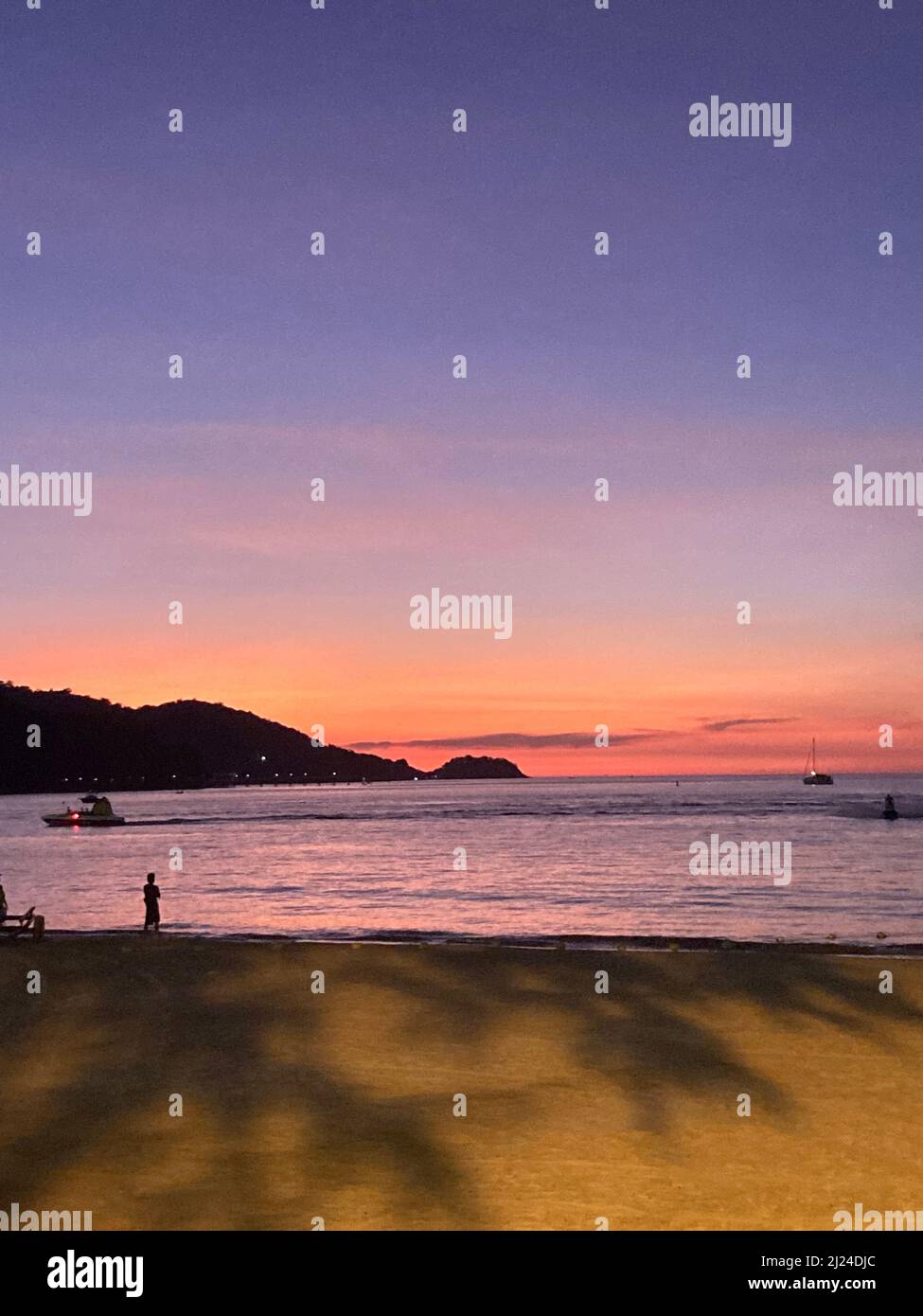 Patong, Thailand. 15th Mar, 2022. Sunset on the beach of Patong. Due to the complicated entry regulations, tourism in Thailand is only slowly picking up again. (to dpa: 'Angkor and Co.: What Southeast Asia vacationers need to be aware of because of Corona') Credit: Carola Frentzen/dpa/Alamy Live News Stock Photo