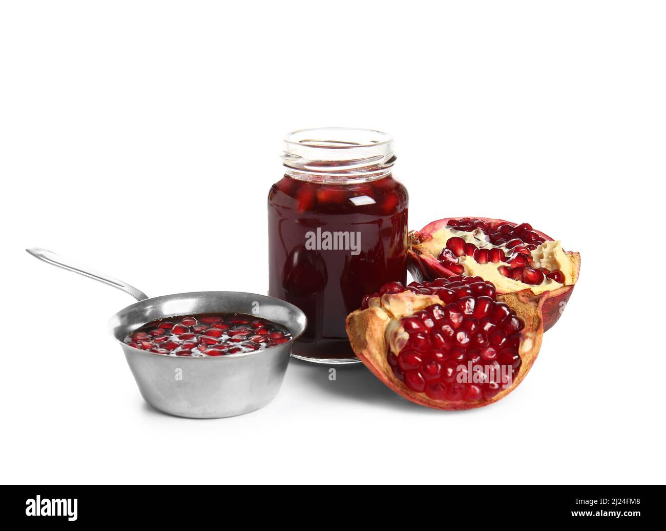 Bowl and jar of pomegranate molasses with fresh fruit on white