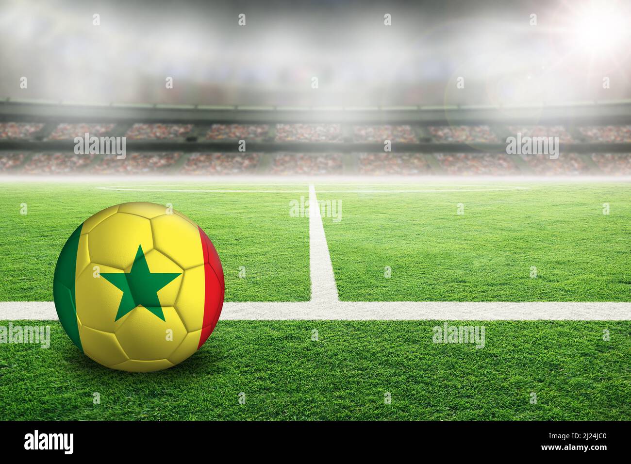 Football in brightly lit outdoor stadium with painted flag of Senegal. Focus on foreground and soccer ball with shallow depth of field on background a Stock Photo