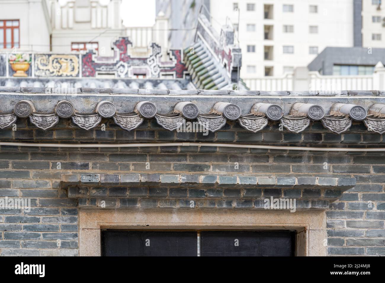 Close-up of ancient building exterior walls and plants in a Chinese style garden Stock Photo