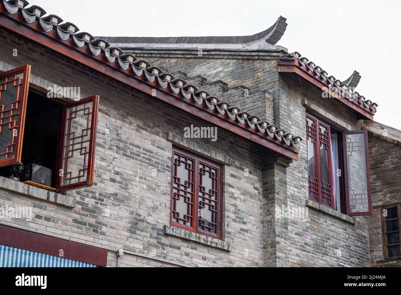 Close-up of ancient building exterior walls and plants in a Chinese style garden Stock Photo