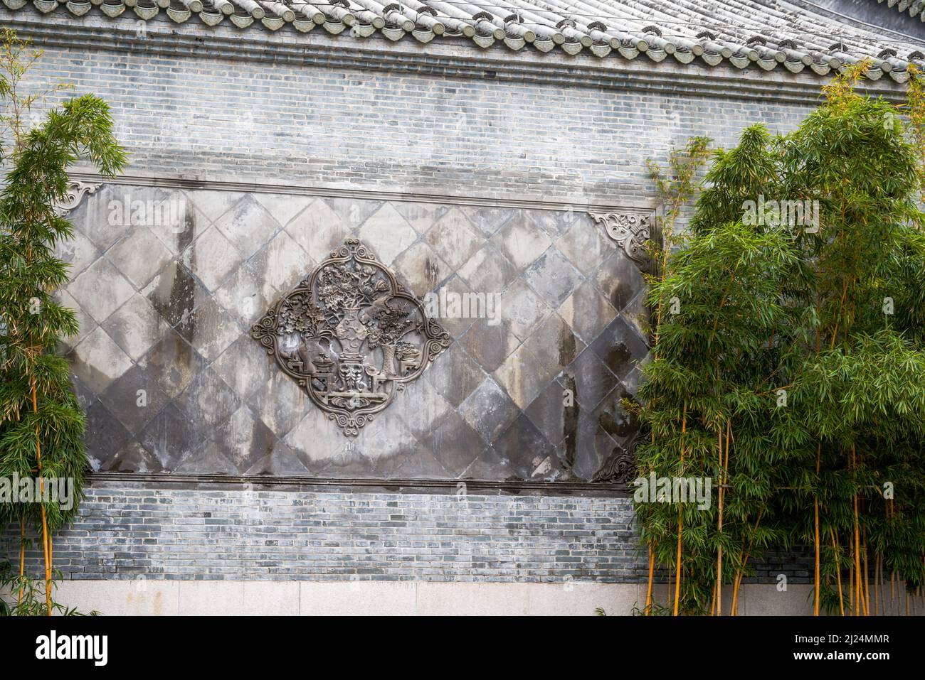 Close-up of ancient building exterior walls and plants in a Chinese style garden Stock Photo