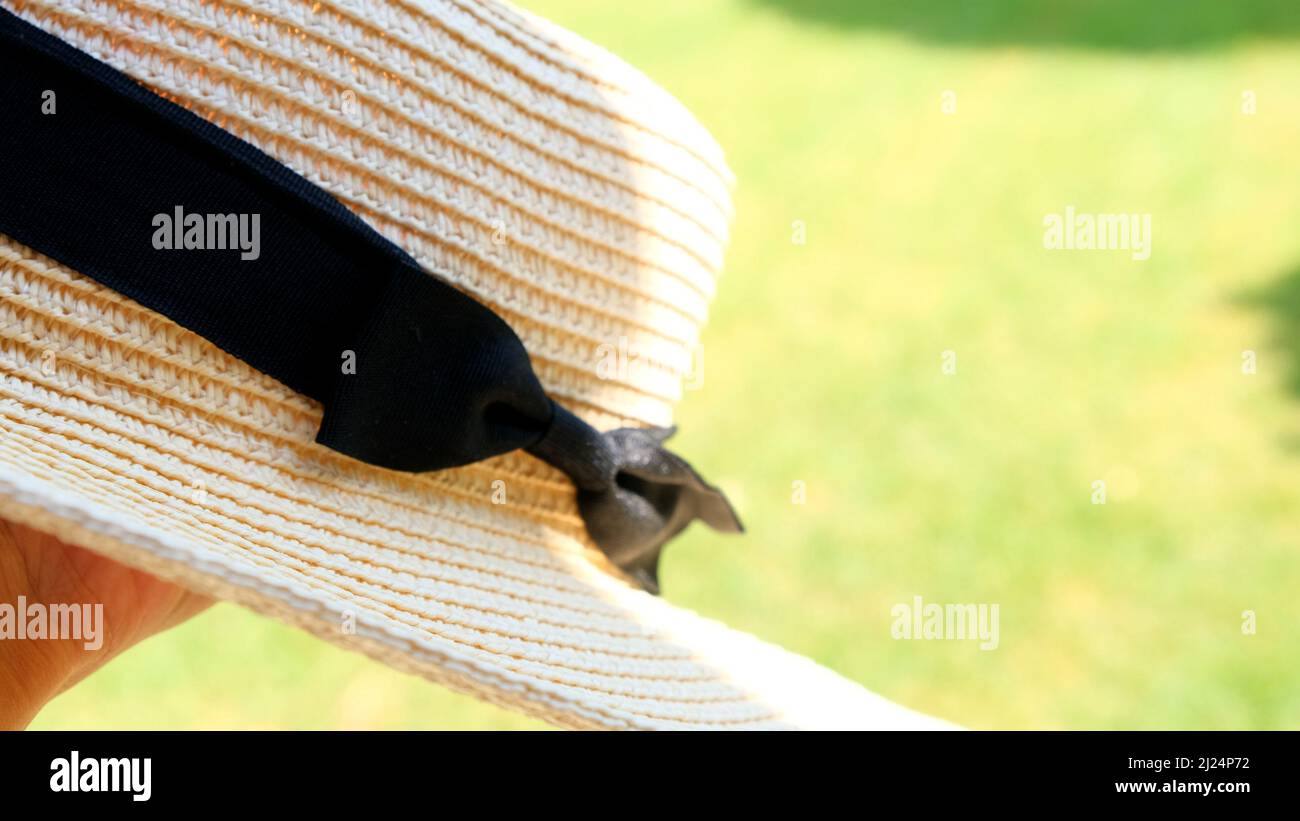 straw hat against the backdrop of a beautiful blue sky and flower ...