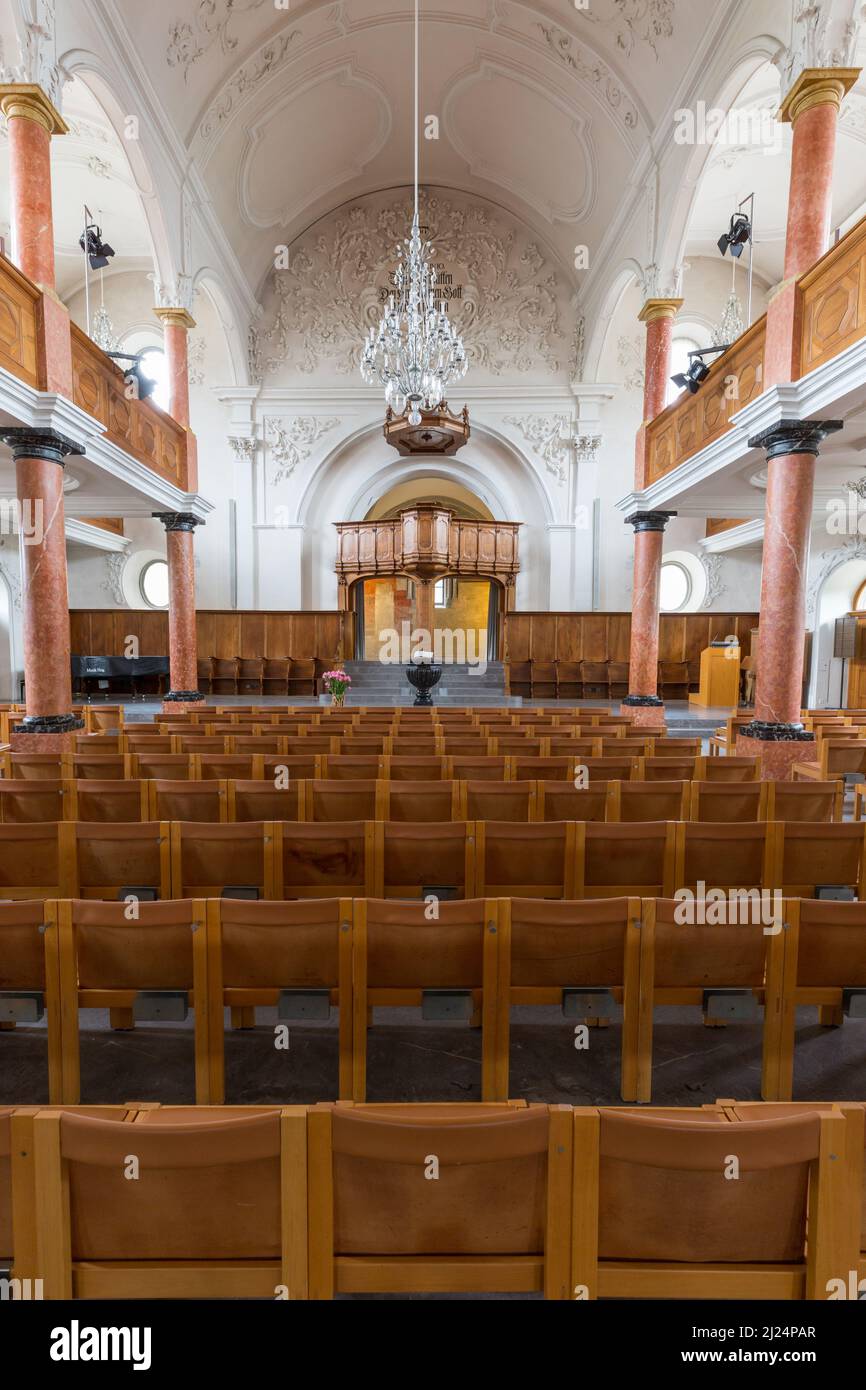 symmetric view on nave of St. Peter church in Zurich with pulpit and chandelier Stock Photo