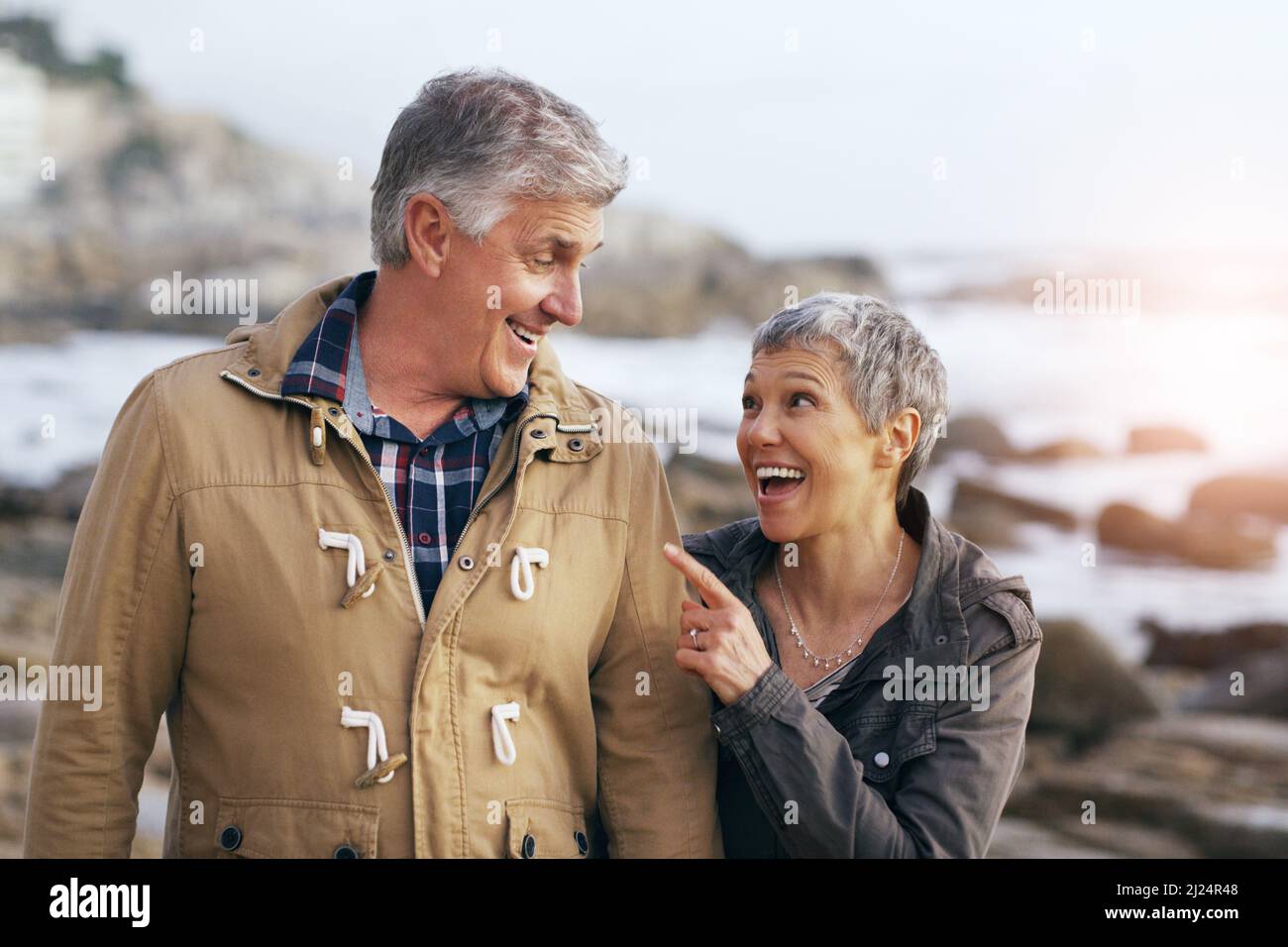 Taking a stroll at the beach with my love. Shot of a beautiful elderly couple taking a walk at the beach. Stock Photo