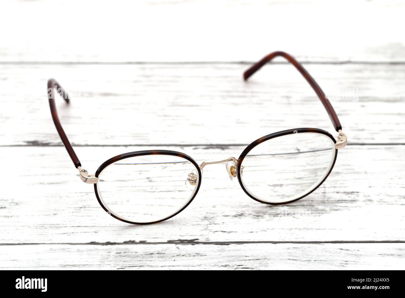 Stylish brown framed glasses on a white wooden table Stock Photo