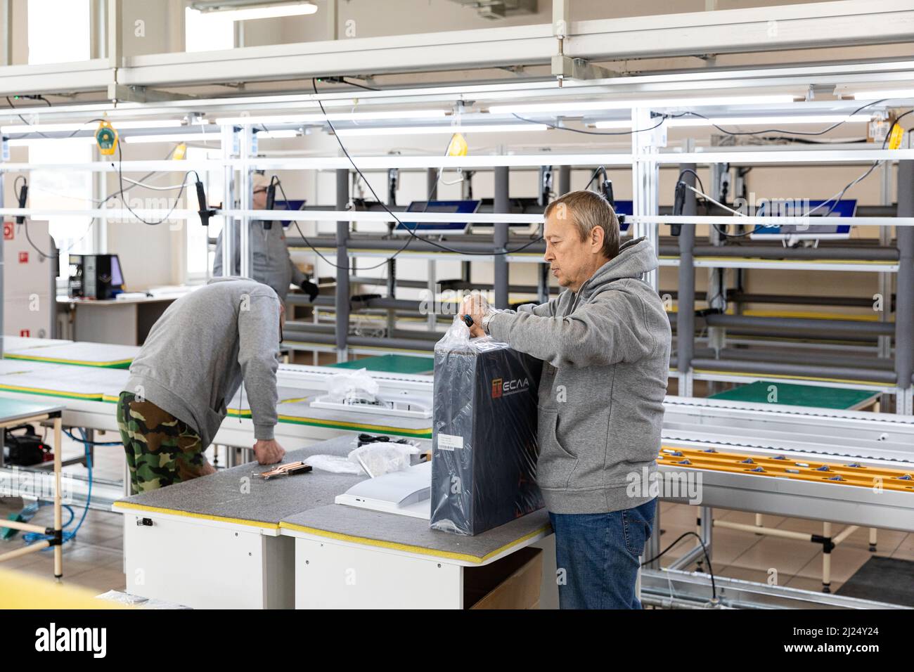 Photo of a plant for assembling monoblocks for computers. Working men