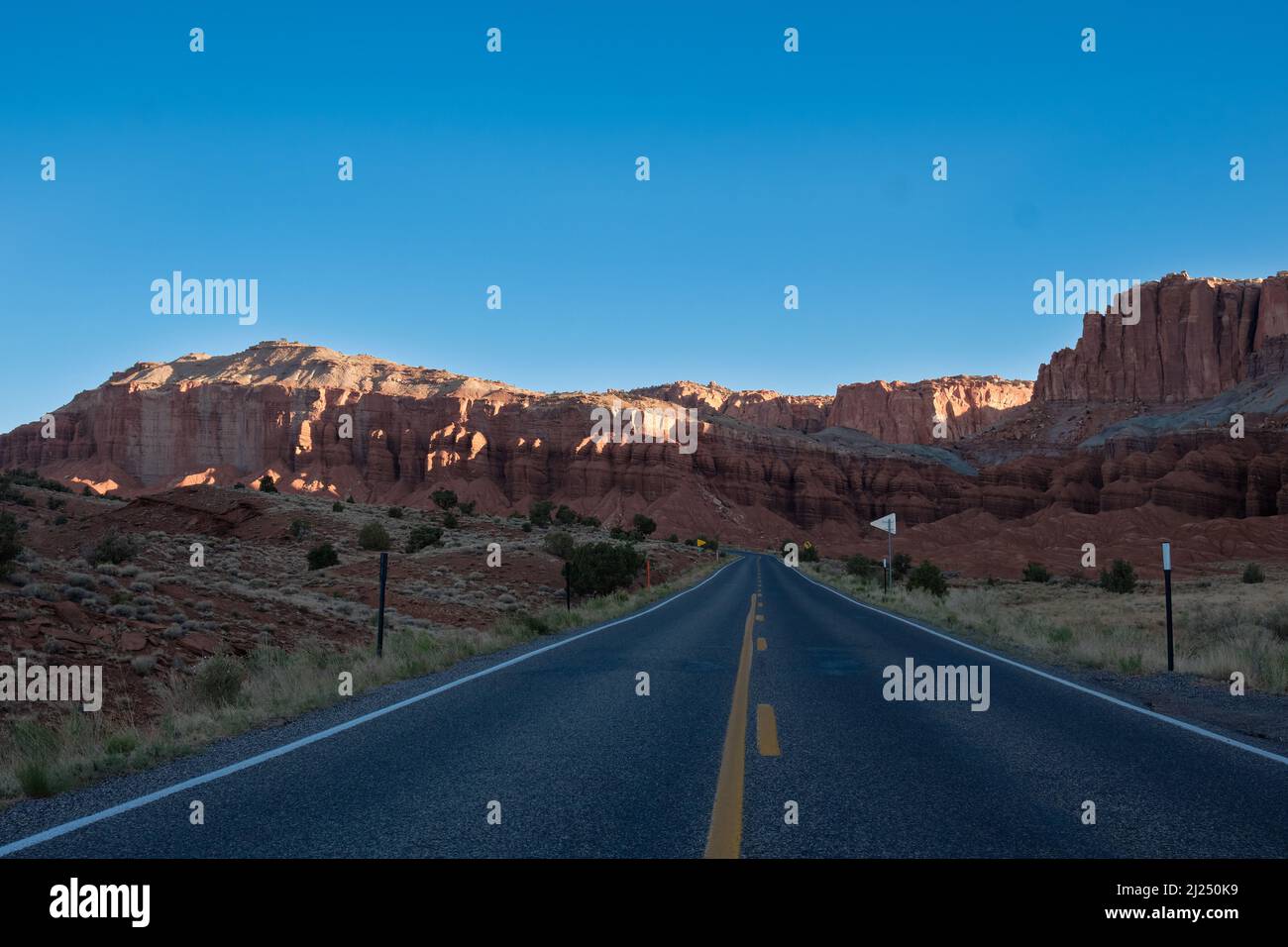 An empty highway asphalt road surrounded by hills Stock Photo - Alamy