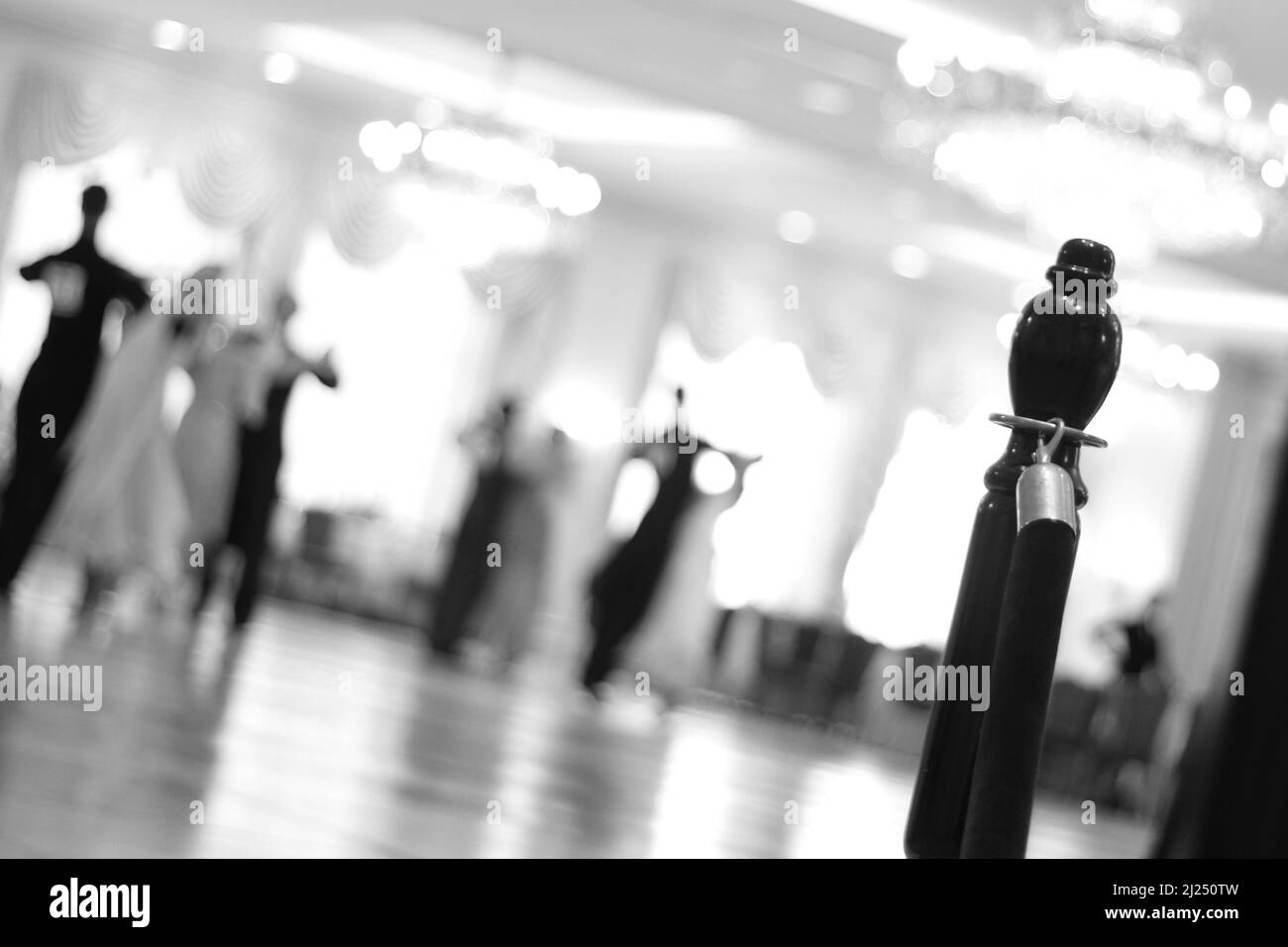 A beautiful view in blurred lights of the dance hall with dancers dancing waltz Stock Photo