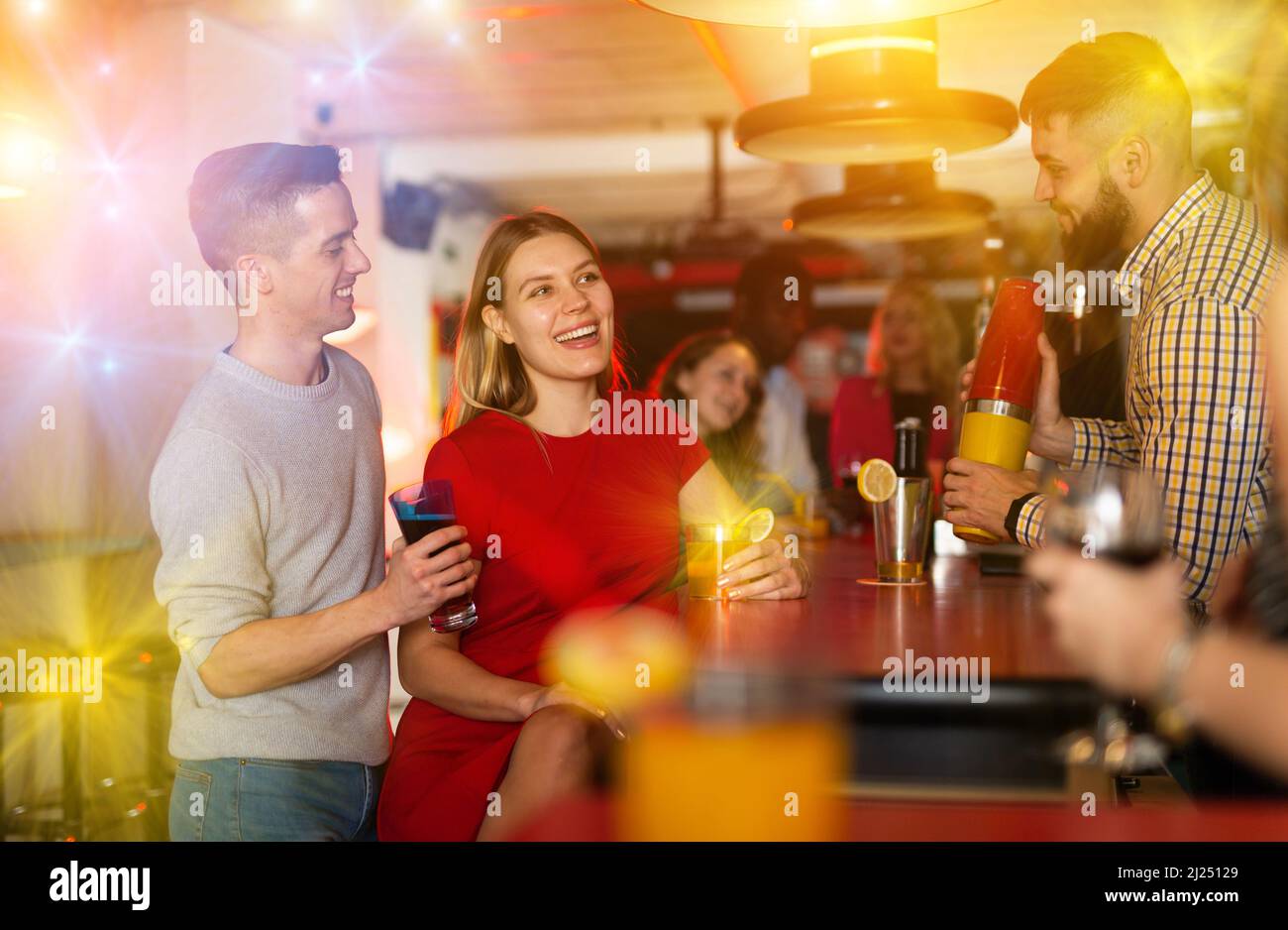 Bartender shaking cocktail for friends in Stock Photo Alamy