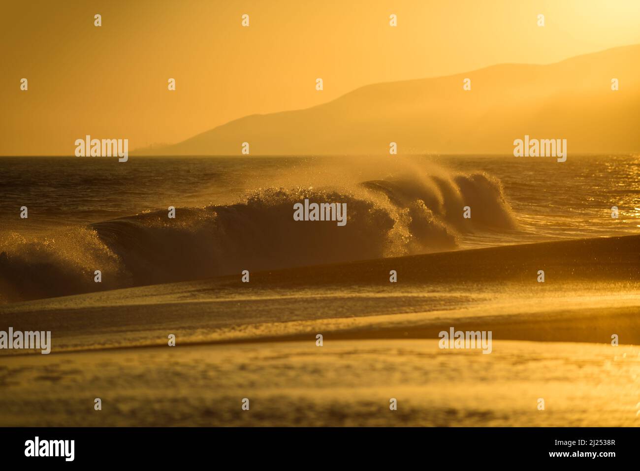 Gold sky and ocean water. Golden sunrise sunset over the sea waves ...