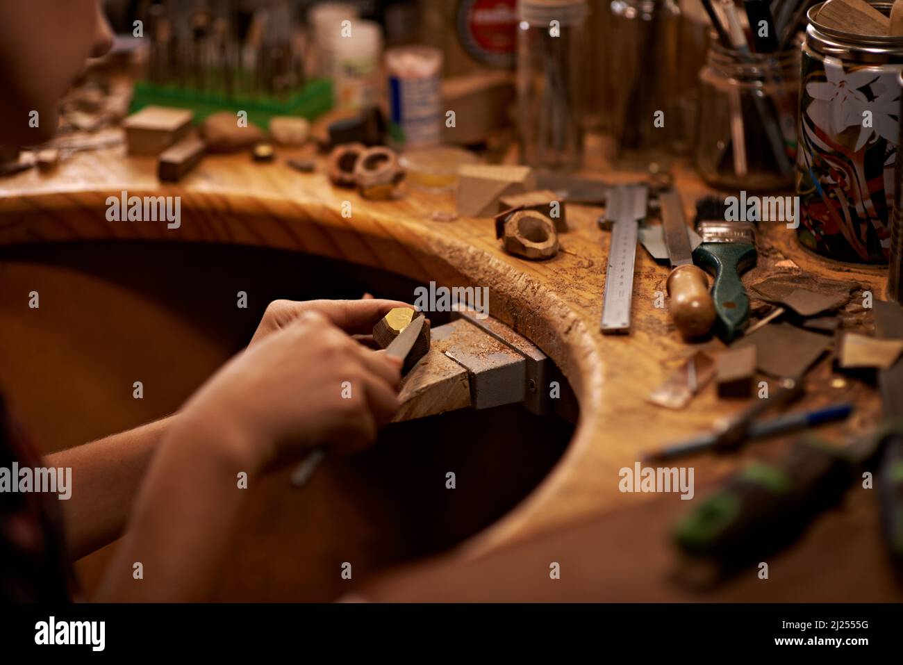 The skills my father taught me. A person using a tool to work on a piece of wood. Stock Photo